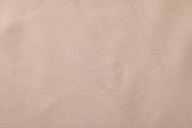 Photo of Texture of beige fabric as background, top view