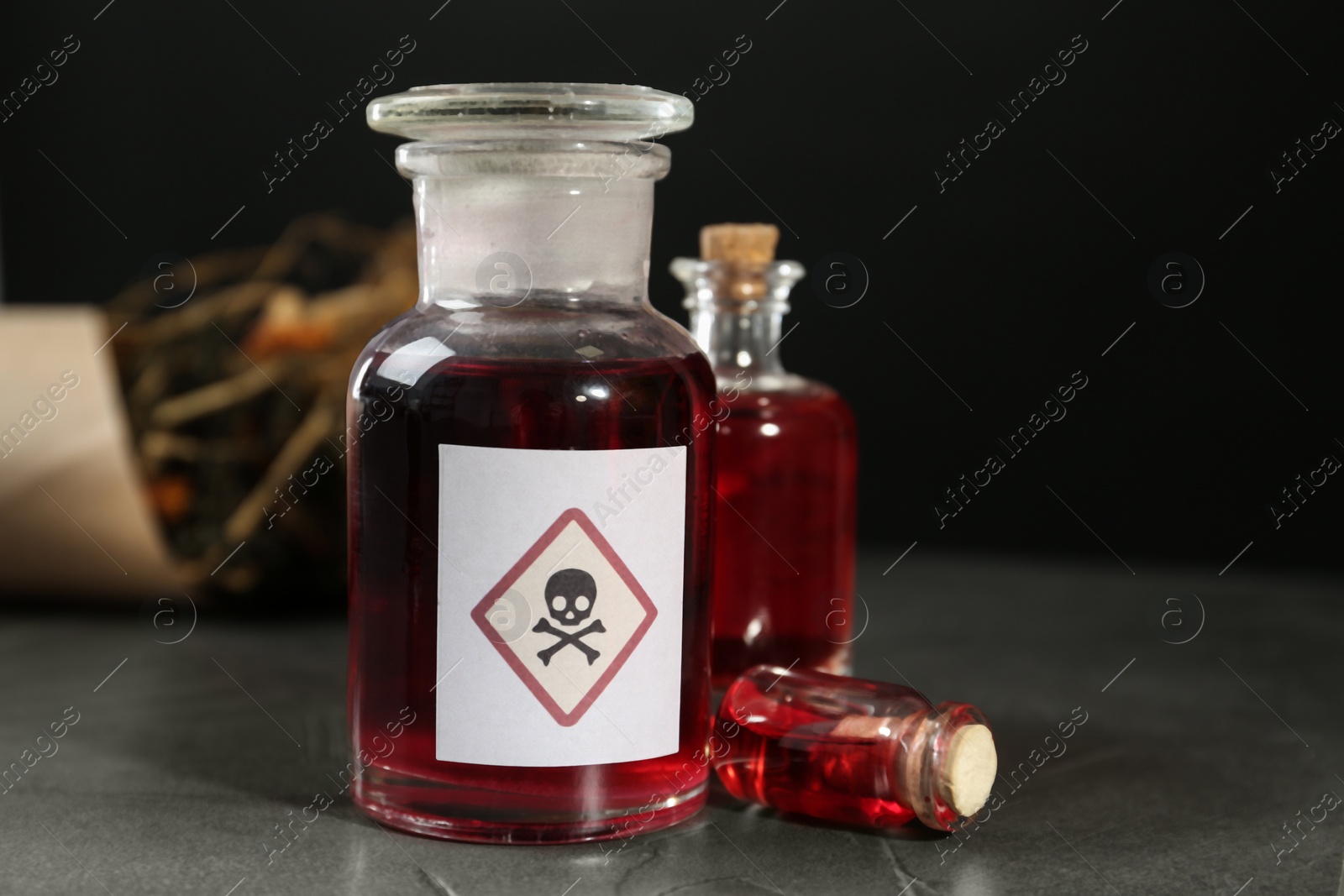Photo of Bottles with poison on grey stone table