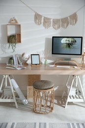 Photo of Stylish home office interior with comfortable workplace