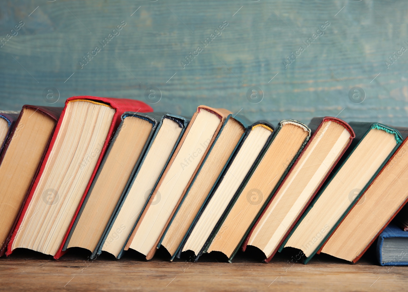 Photo of Collection of old books on wooden shelf