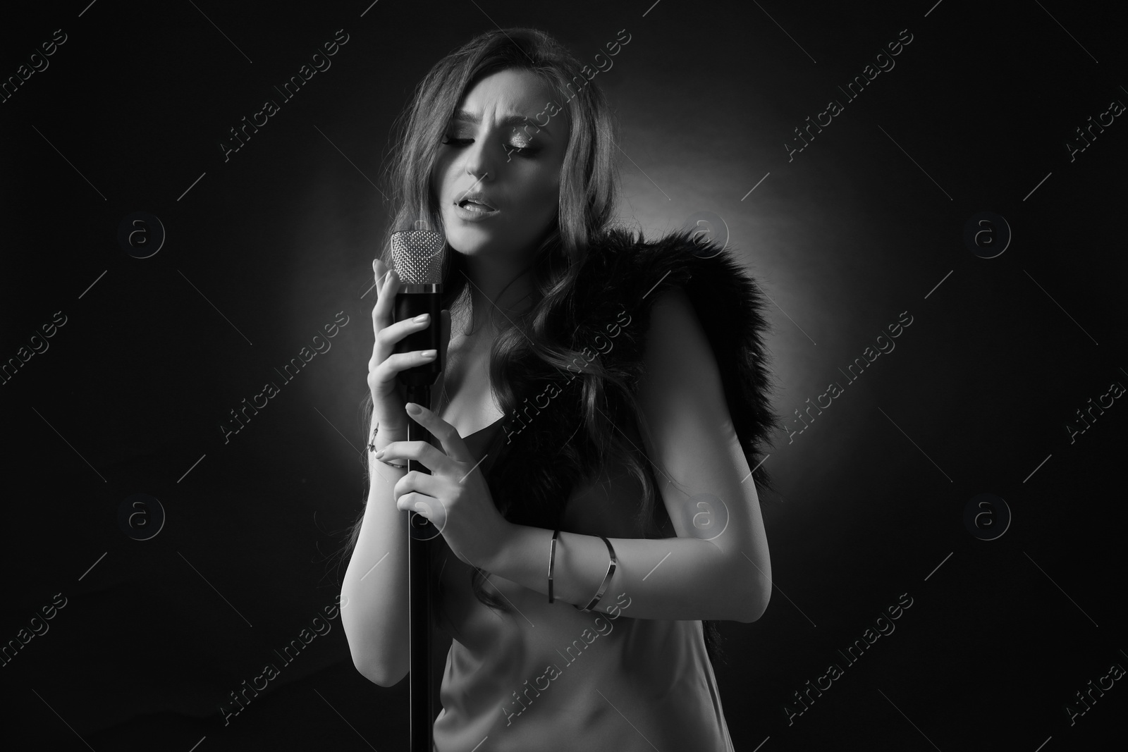 Image of Beautiful singer with microphone, black and white effect