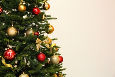 Beautifully decorated Christmas tree on light background