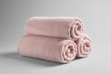 Fresh soft rolled towels on light background