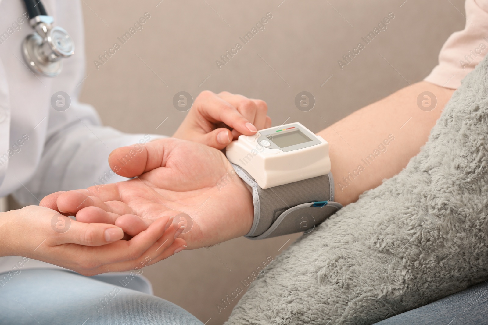 Photo of Nurse measuring blood pressure of elderly man against grey background, closeup. Assisting senior generation