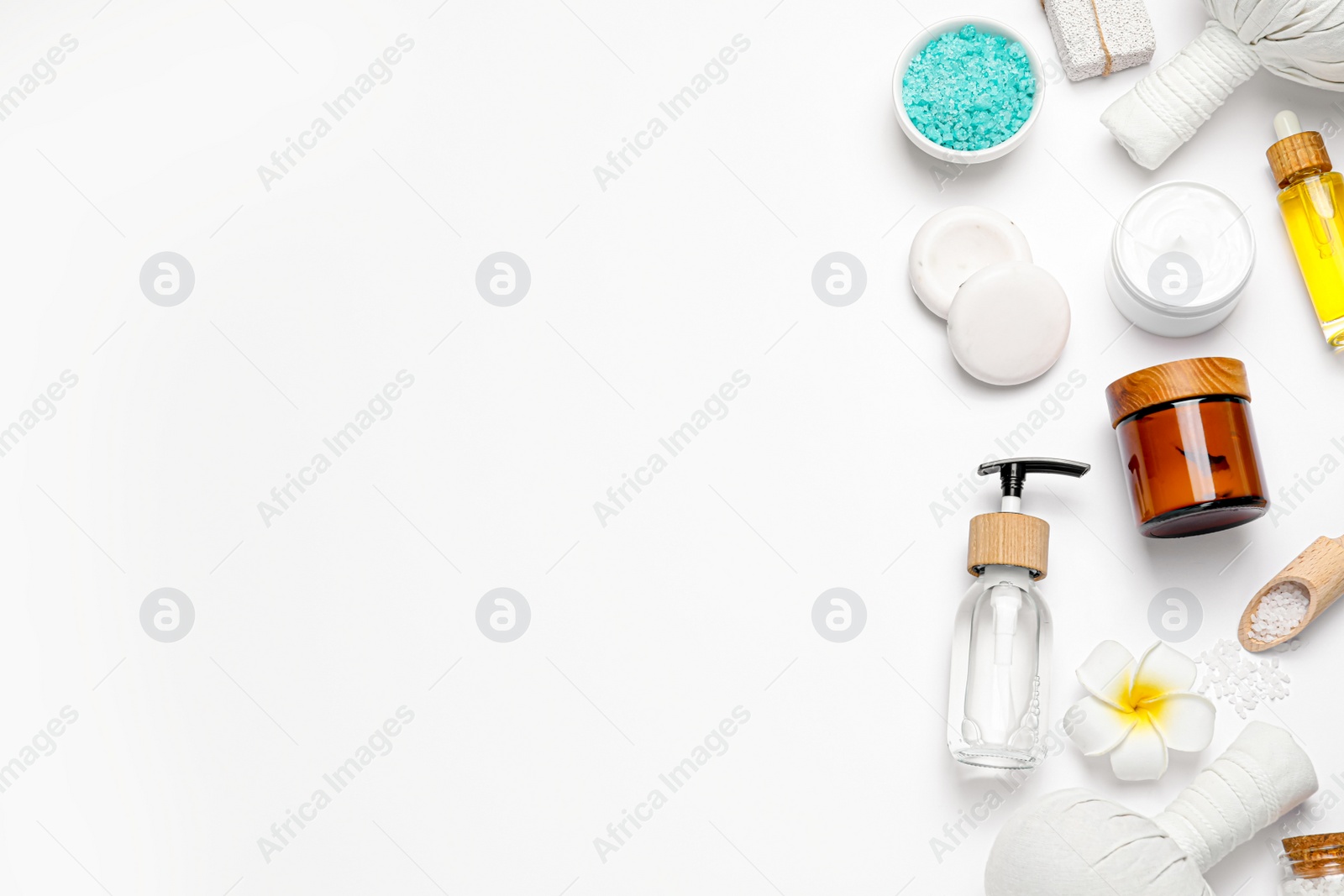 Photo of Beautiful spa composition with herbal massage bags and different care products on white background, flat lay. Space for text