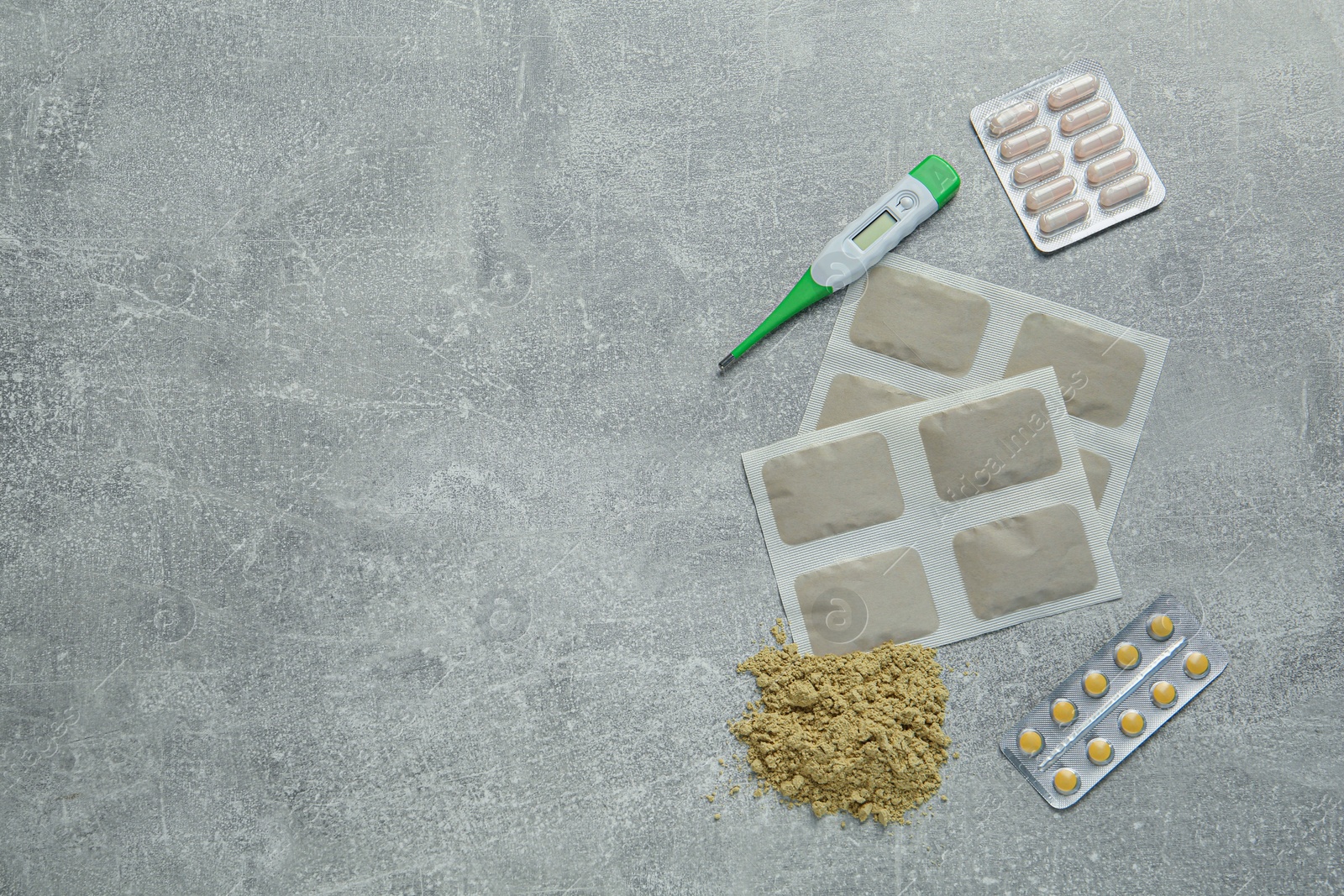 Photo of Mustard plasters, pills and thermometer on light grey table, flat lay. Space for text