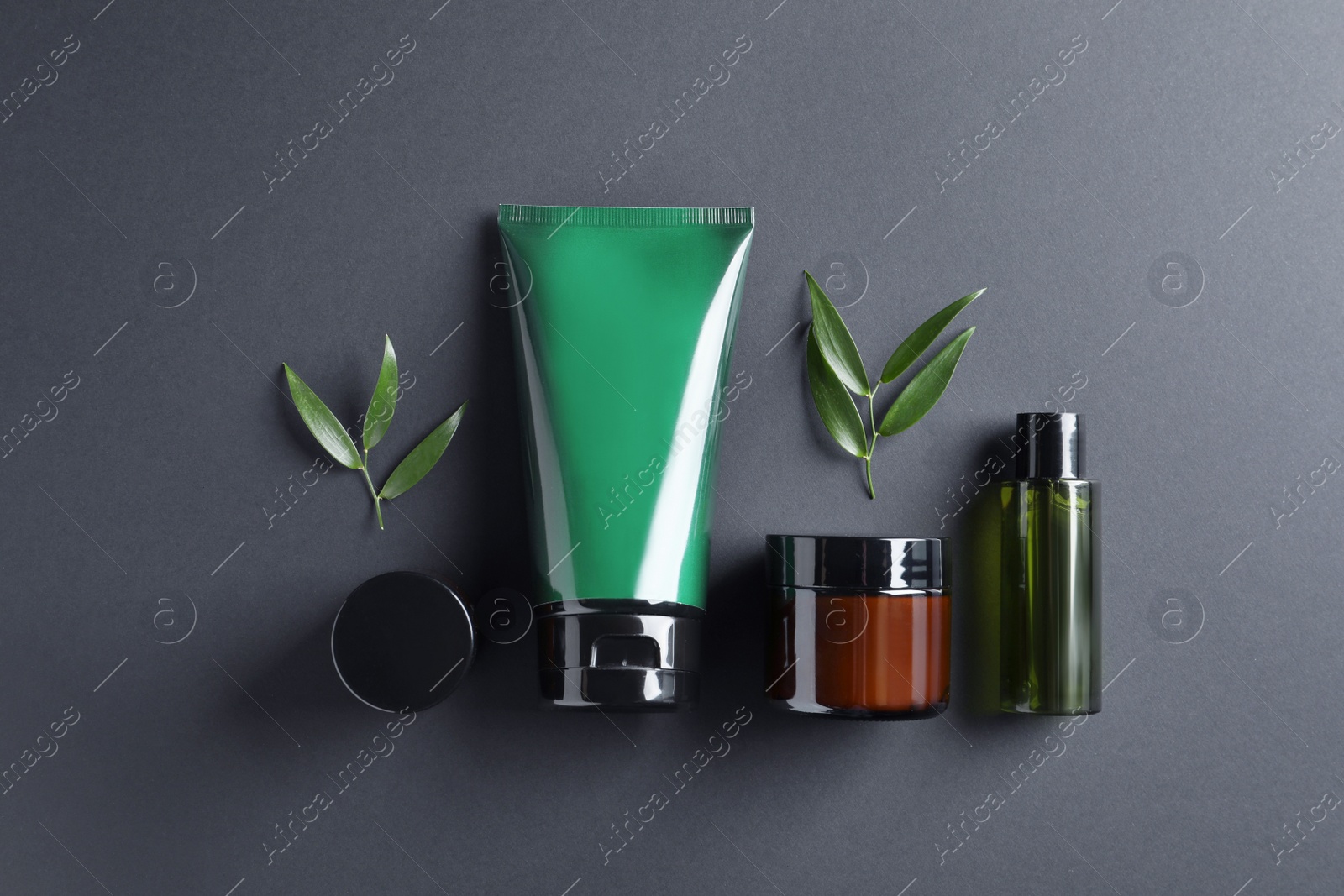 Photo of Facial cream and other men's cosmetic products on black background, flat lay