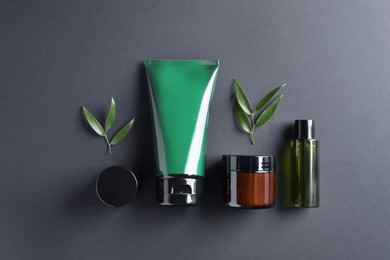 Photo of Facial cream and other men's cosmetic products on black background, flat lay