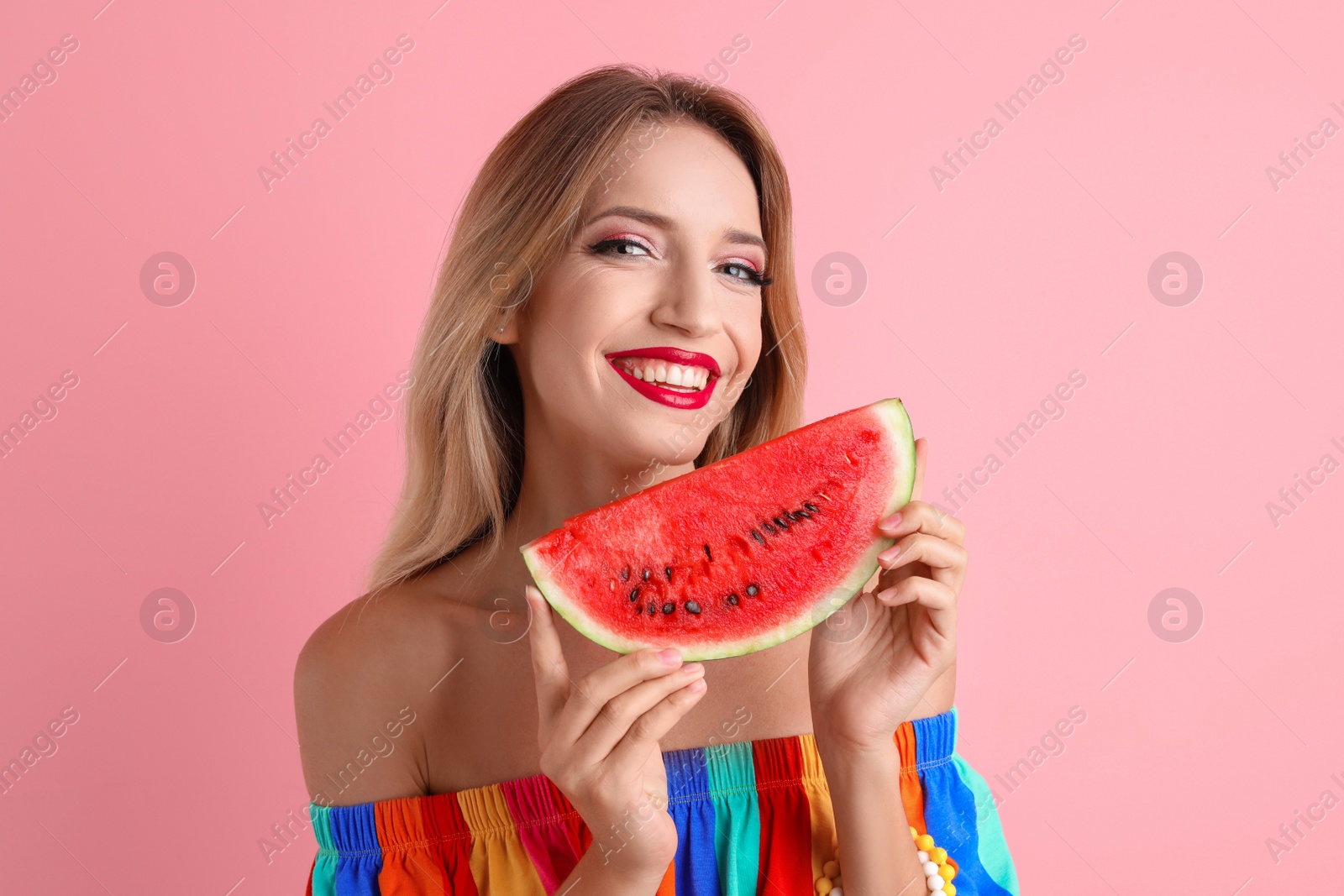 Photo of Pretty young woman with juicy watermelon on color background