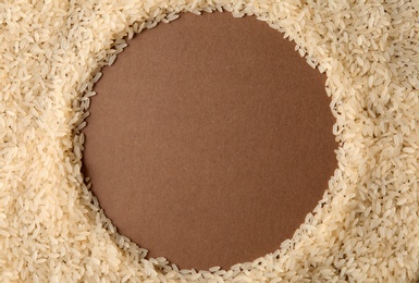 Round frame made with parboiled rice on color background, top view. Space for text
