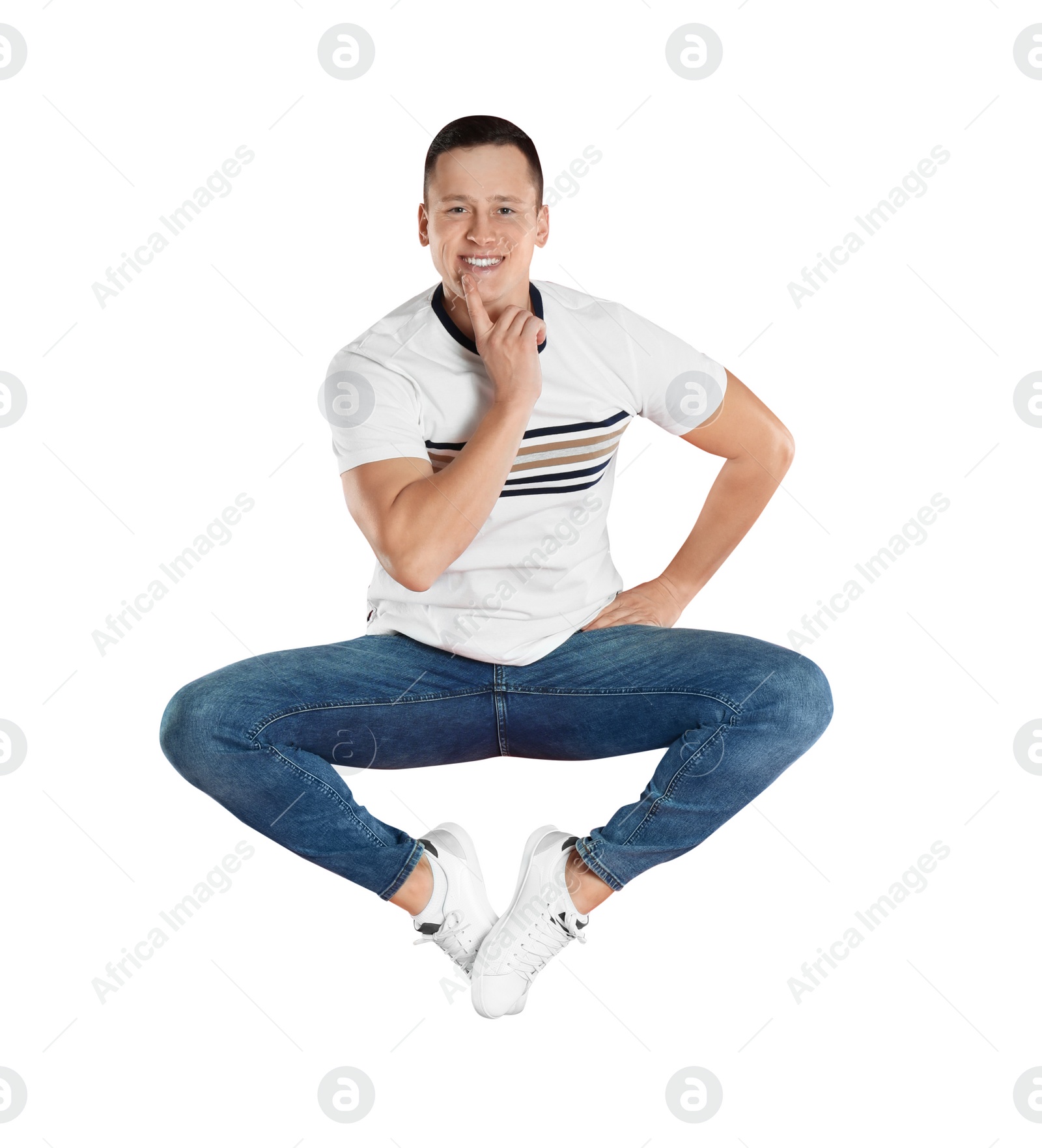 Photo of Handsome young man jumping on red background