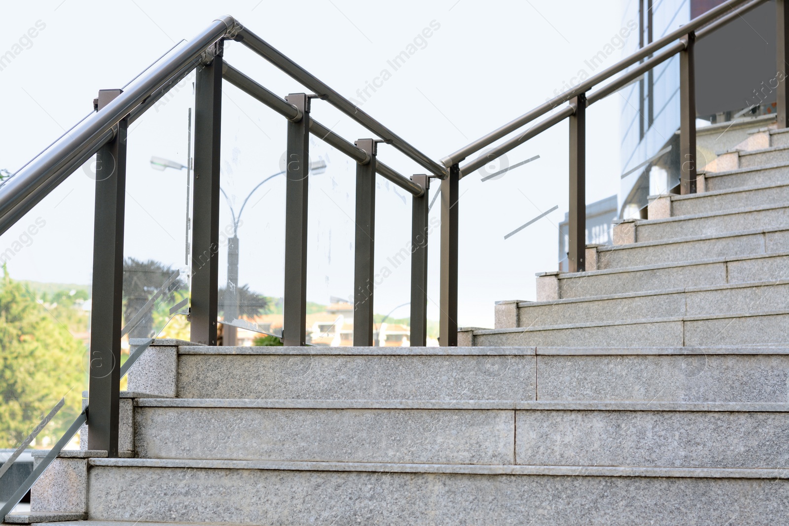 Photo of Stairs with metal handrailing outdoors on sunny day