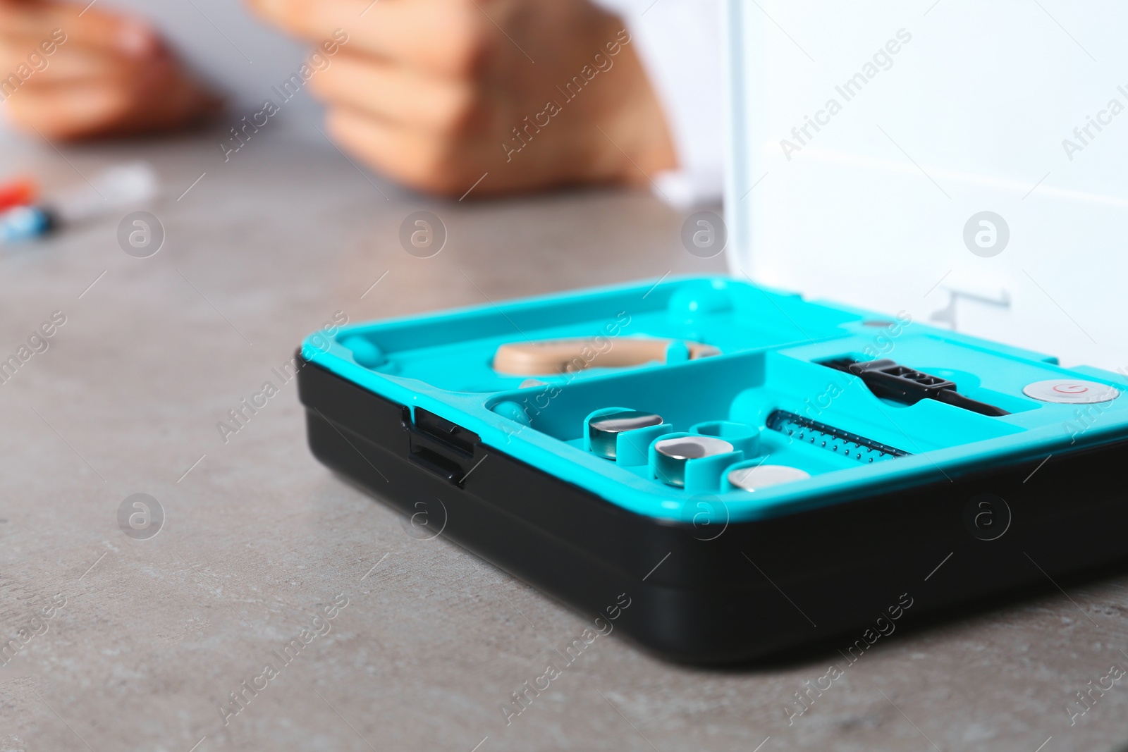 Photo of Hearing aid kit on table, closeup with space for text