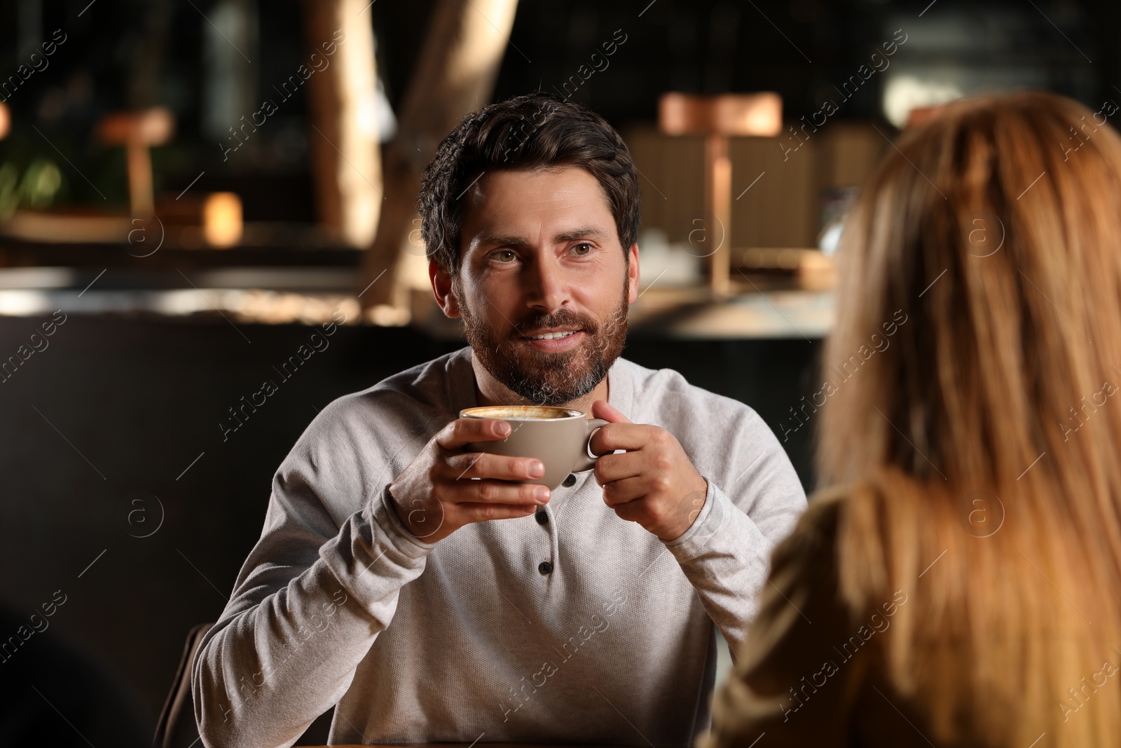 Photo of Romantic date. Lovely couple spending time together in cafe