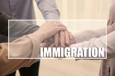 Image of Immigration concept. People putting hands together, closeup view