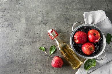 Flat lay composition with delicious apple cider on gray table, space for text