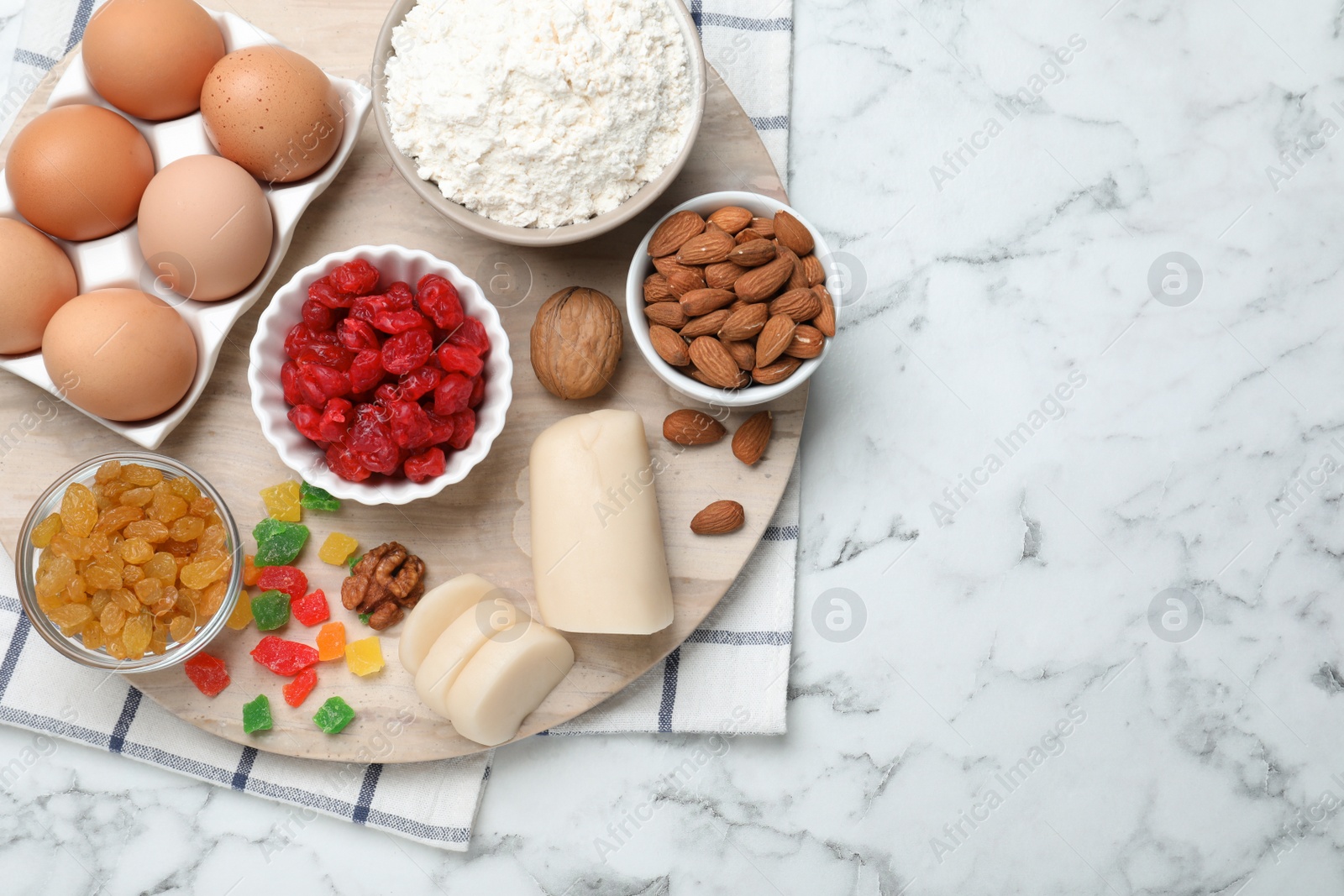 Photo of Ingredients for homemade Stollen on white marble table, top view. Baking traditional German Christmas bread