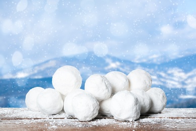 Snowballs against blurred mountains. Winter outdoor activity