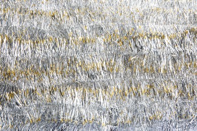 Photo of Sparkling bright tinsel as background. Festive decoration