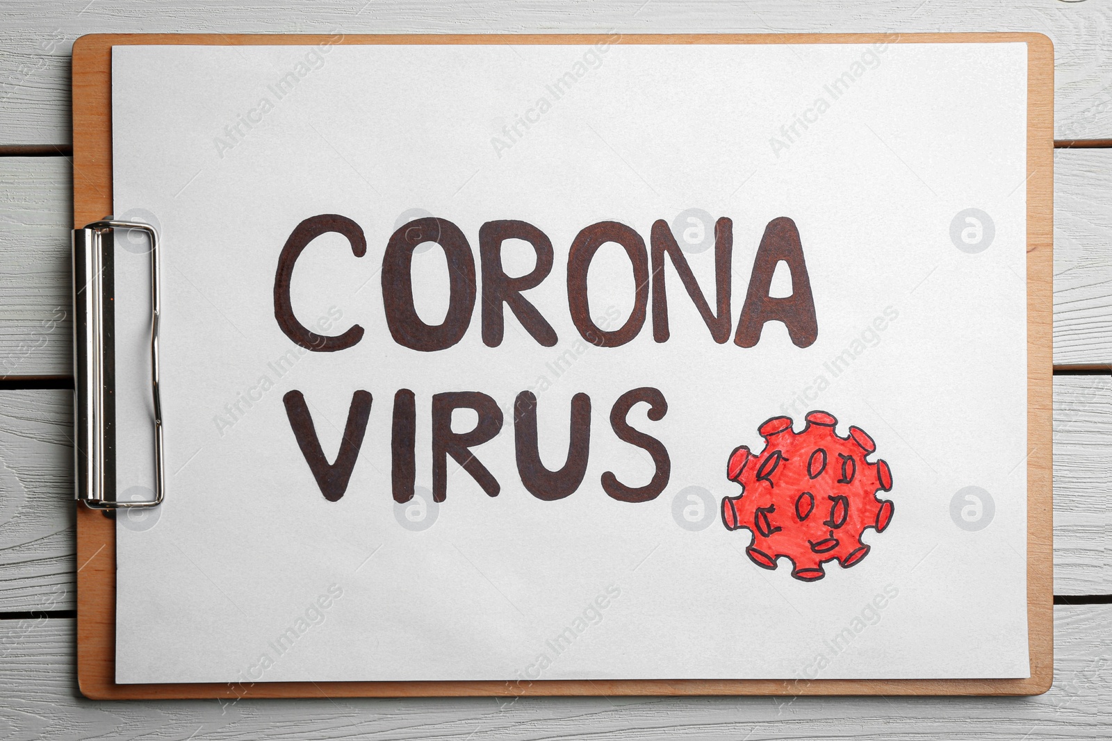 Photo of Clipboard with words CORONA VIRUS on white wooden background, top view