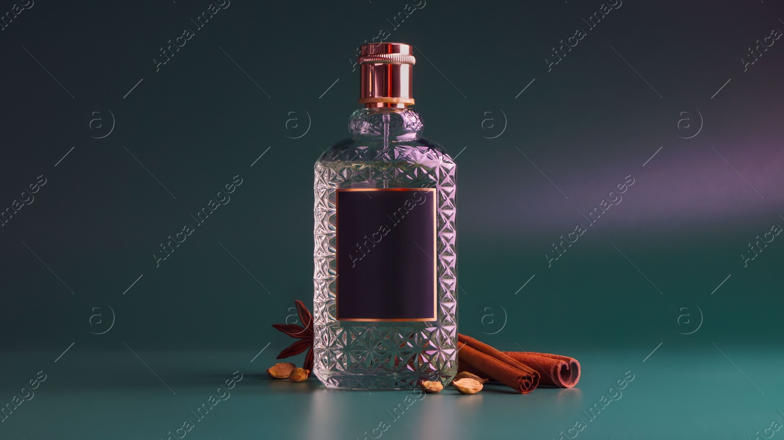 Photo of Bottle of luxurious perfume and spices on color background