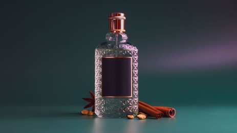 Photo of Bottleluxurious perfume and spices on color background