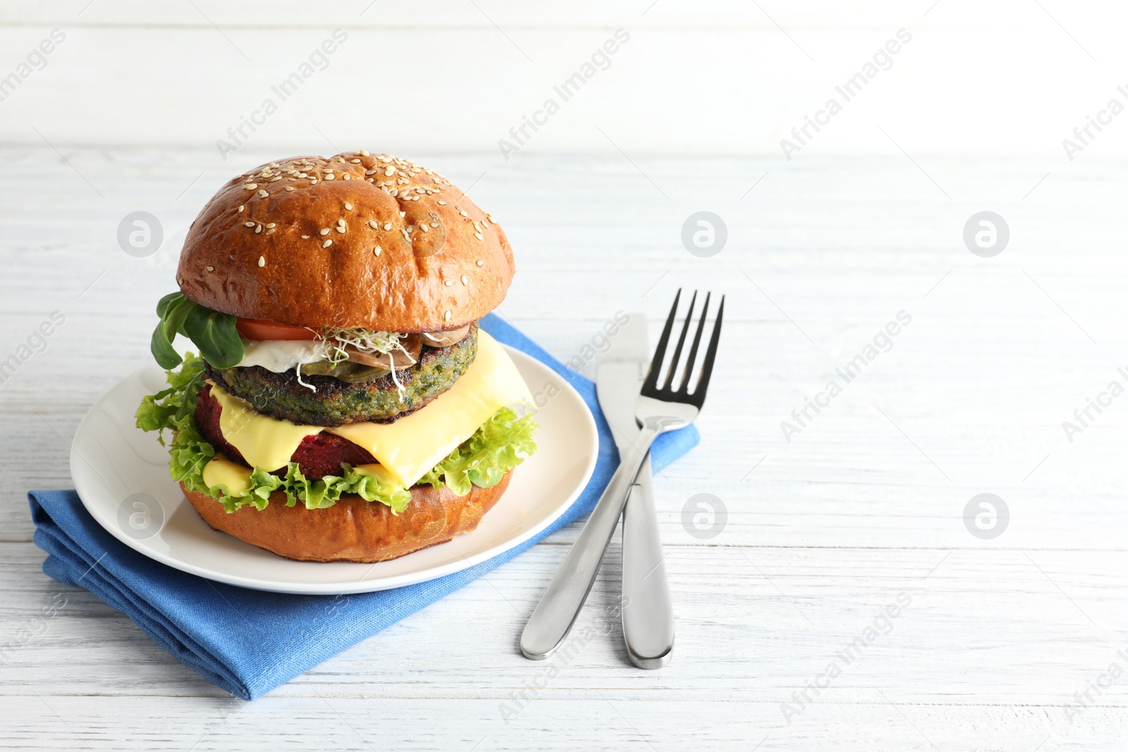 Photo of Vegan burger with beet and falafel patties served on white table. Space for text