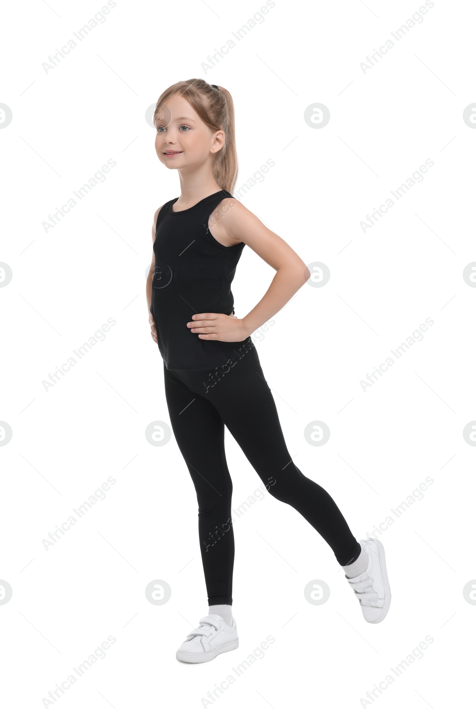 Photo of Little girl doing morning exercise on white background