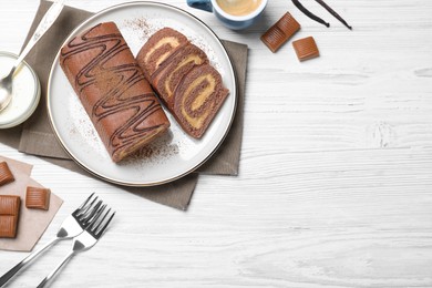 Photo of Tasty chocolate cake roll with cream on white wooden table, flat lay. Space for text