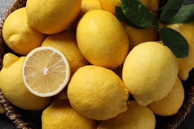 Photo of Fresh lemons in wicker basket, top view