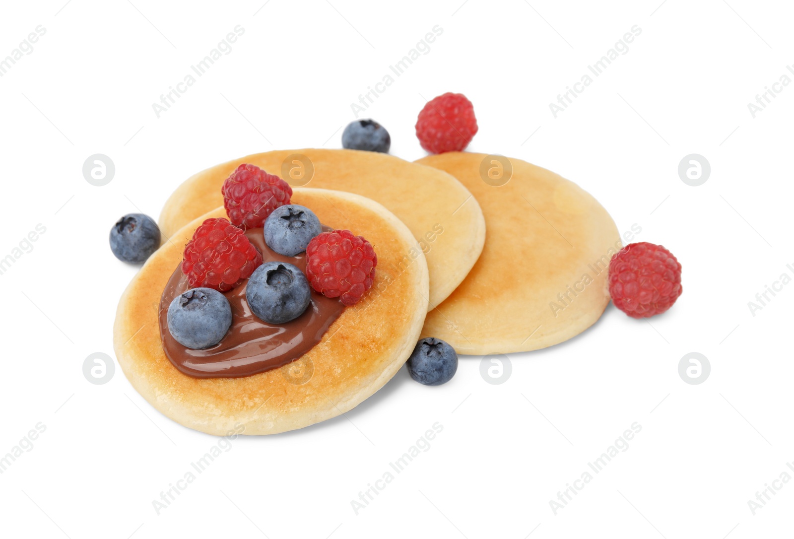 Photo of Tasty pancakes with chocolate spread and berries isolated on white