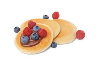 Tasty pancakes with chocolate spread and berries isolated on white