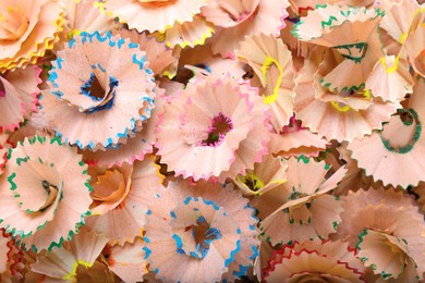 Photo of Pile of colorful pencil shavings as background, top view