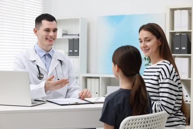Photo of Gastroenterologist consulting woman and her daughter in clinic