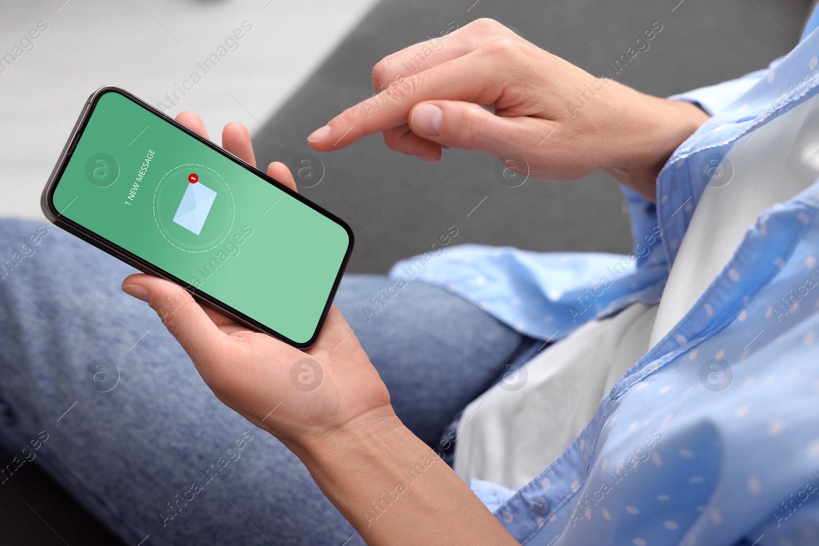 Image of Woman checking new message on mobile phone indoors, closeup