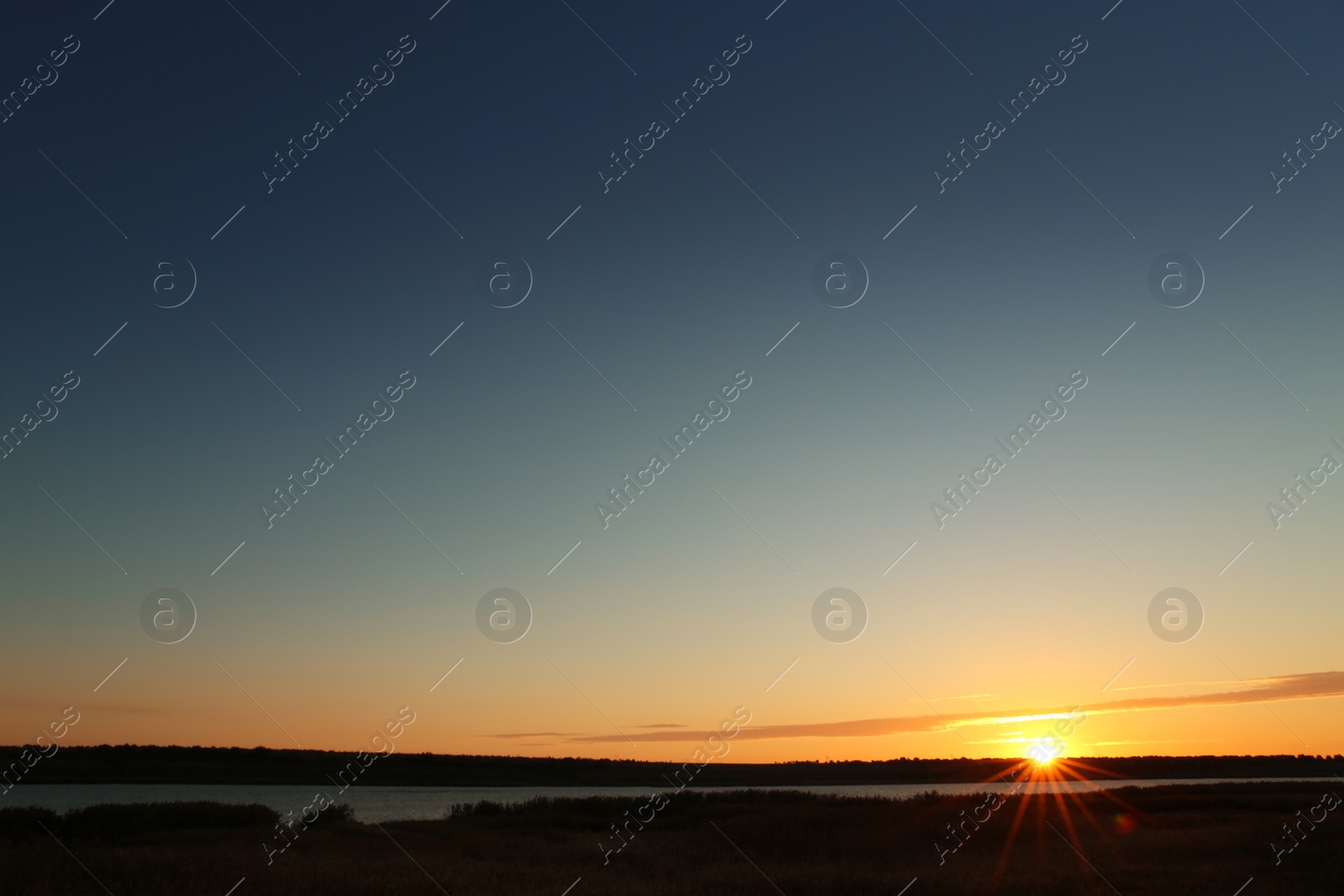 Photo of Picturesque view of beautiful sunrise on riverside. Morning sky