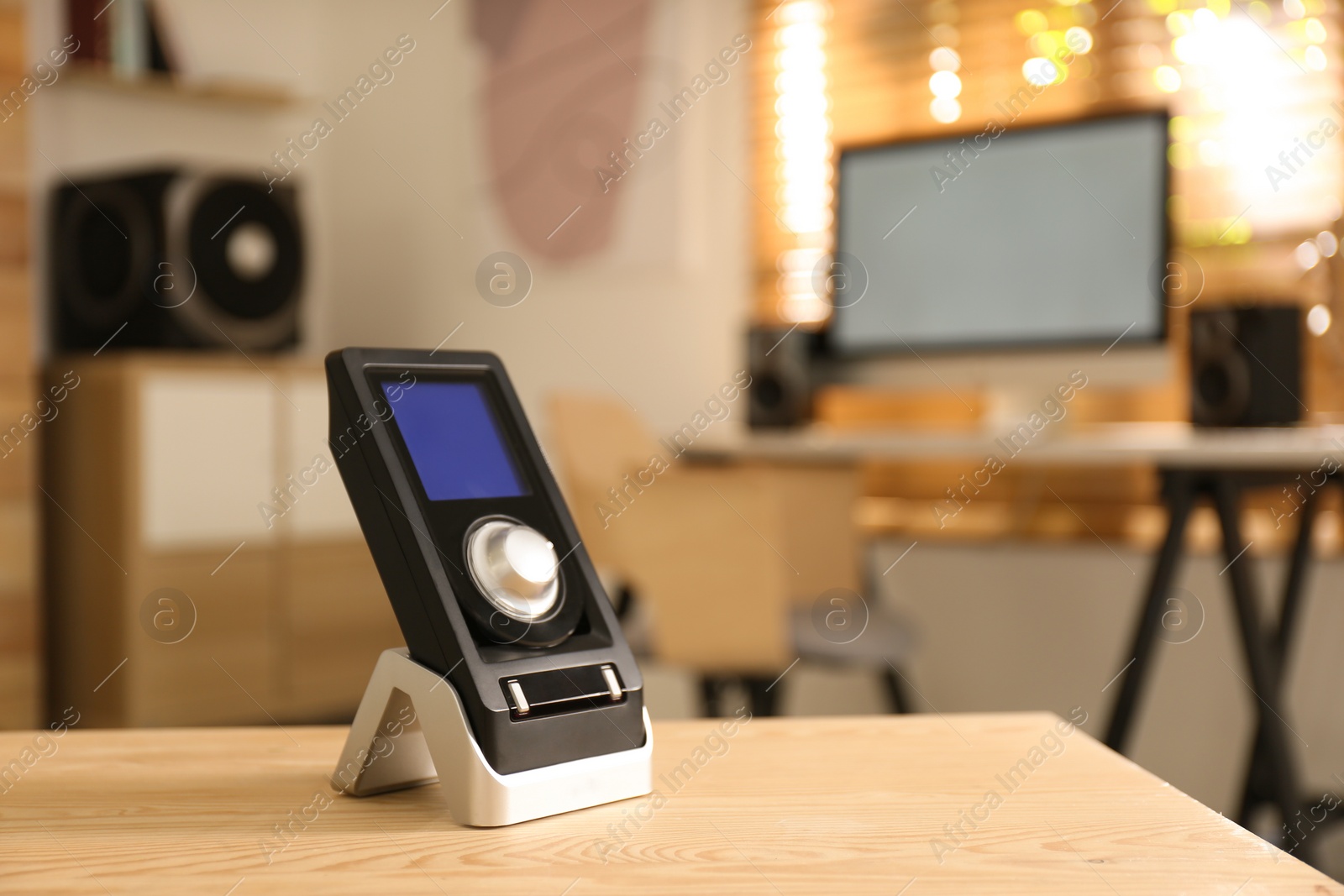 Photo of Remote control of audio speaker system on wooden table in room. Space for text