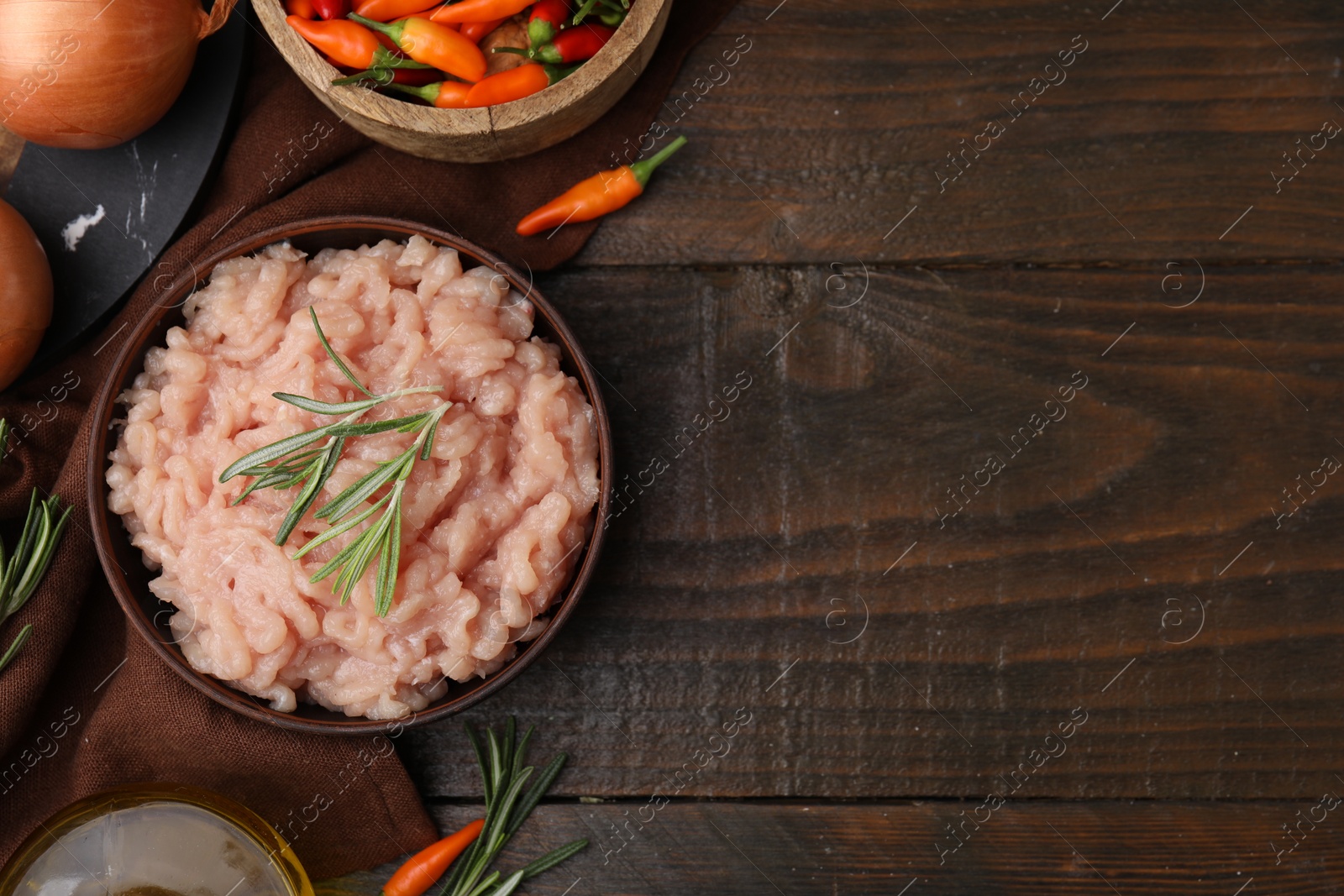 Photo of Flat lay composition with fresh raw minced meat and products on wooden table. Space for text