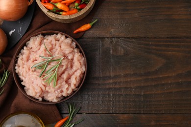 Photo of Flat lay composition with fresh raw minced meat and products on wooden table. Space for text