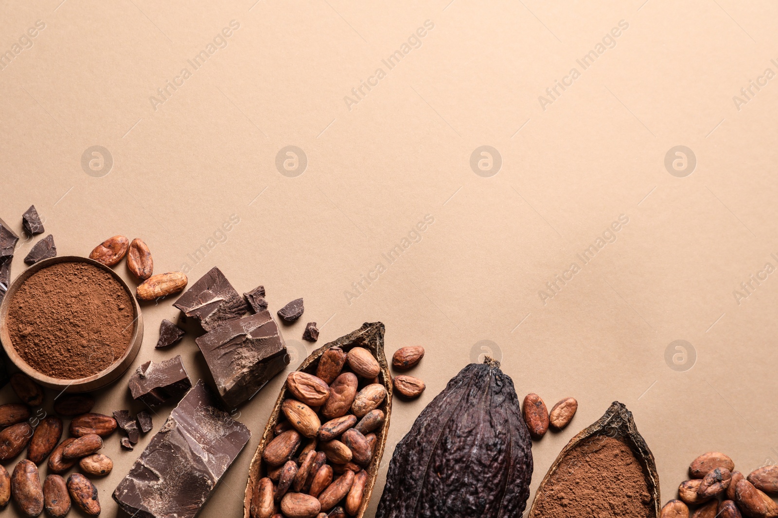 Photo of Flat lay composition with cocoa pods and chocolate on beige background, space for text