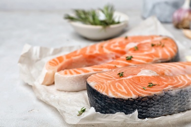 Photo of Fresh raw salmon steaks on table, closeup