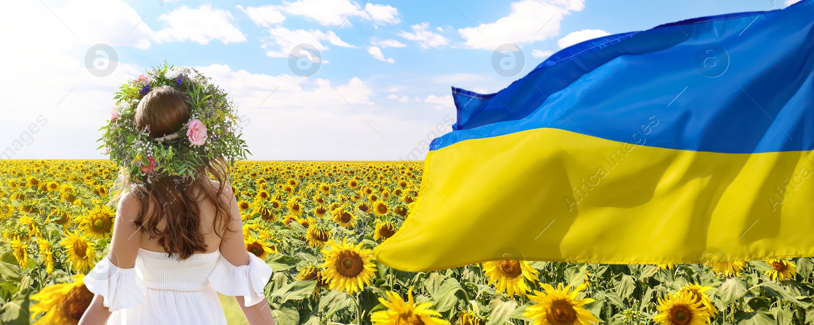 Image of Pray for Ukraine. Ukrainian flag waving near young woman with flower wreath in sunflower field on sunny day, banner design