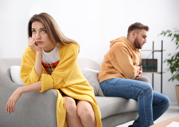 Unhappy woman after quarrel with her boyfriend at home. Relationship problems