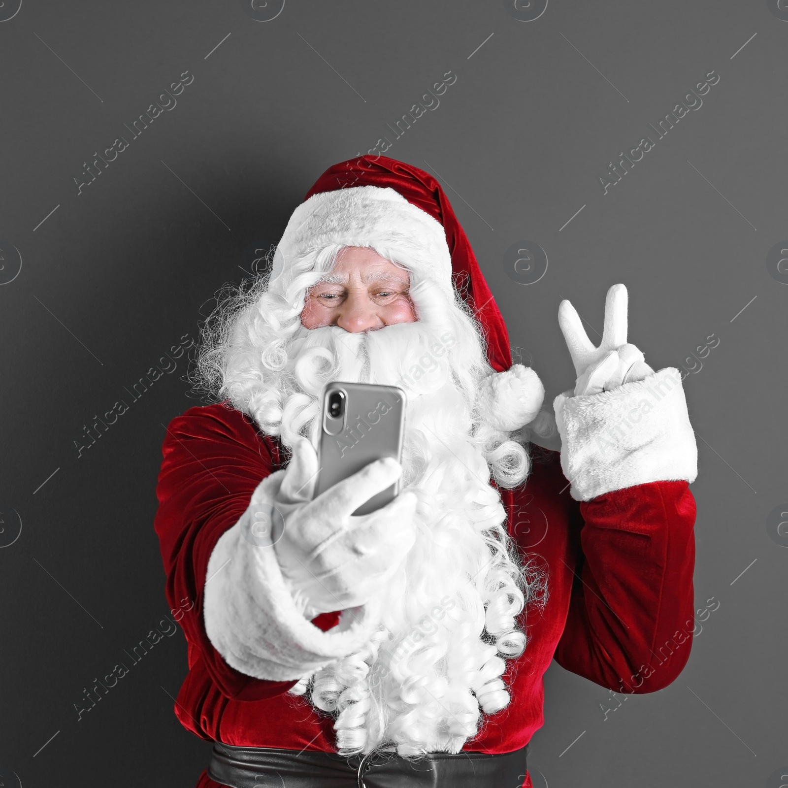 Photo of Authentic Santa Claus taking selfie on grey background