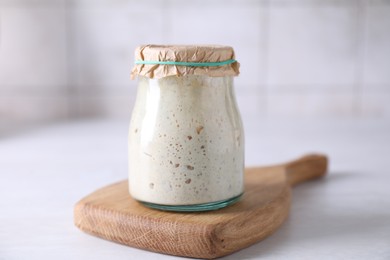 Photo of Sourdough starter in glass jar on light table