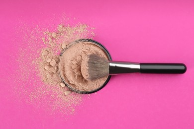 Photo of Makeup brush and face powder on bright pink background, flat lay