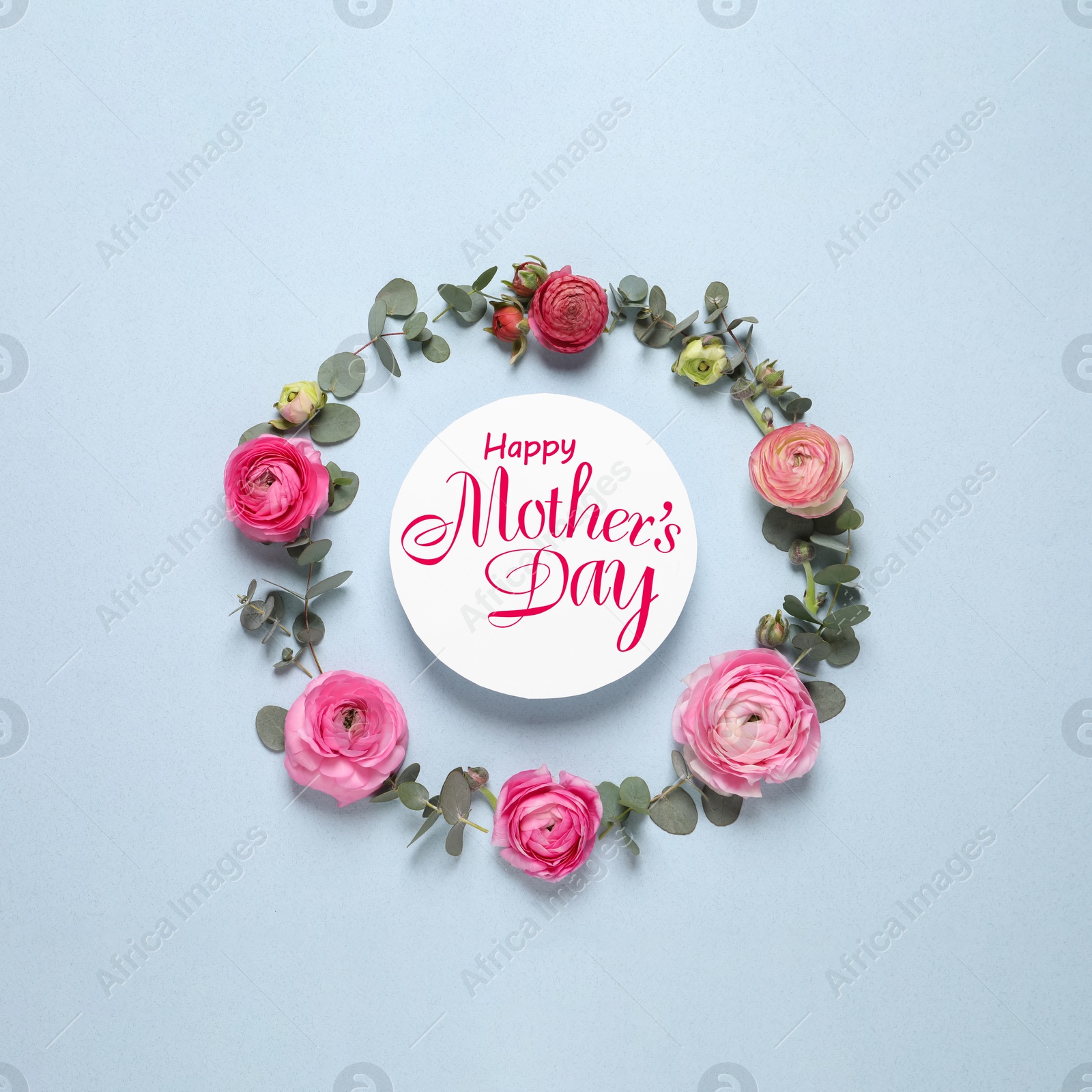 Image of Happy Mother's Day. Frame of beautiful ranunculus flowers and greeting card on light blue background, flat lay