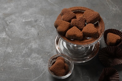 Photo of Delicious heart shaped chocolate candies on grey table. Space for text