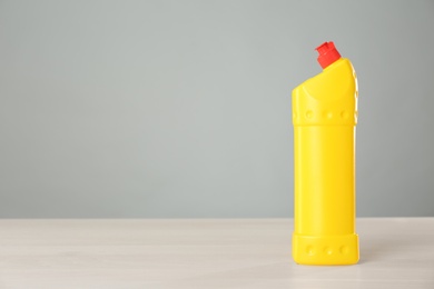 Photo of Bottle of cleaning product on light table. Space for text