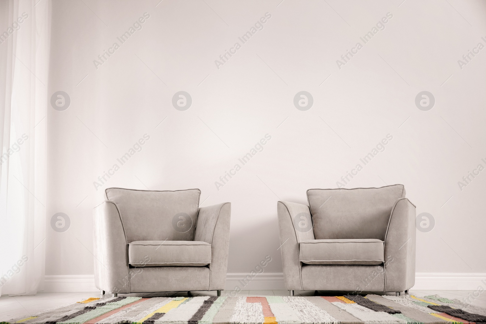 Photo of Living room interior with comfortable armchairs near wall